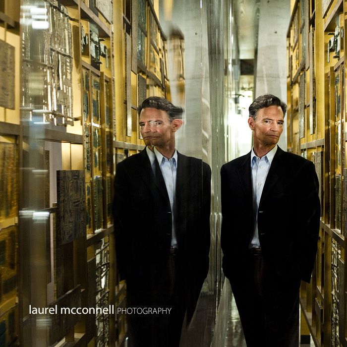 a serious portrait of Leonard Garfield of the Museum of History and Industry at the Seattle Library, James Bond style