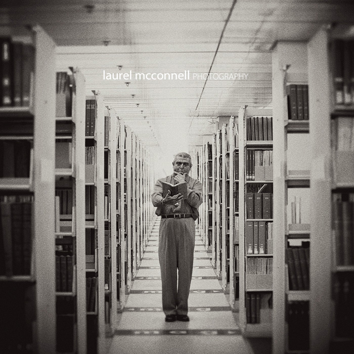 Seattle Municipal Court Judge Michael Hurtado poses thoughtfully for a portrait at the Seattle Library among old law books